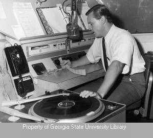 WSB-FM disc jockey operating radio console