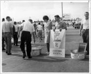 Connie Alonso, George Terenzio, and Wally Wroten manning collection tubs at gates to Eastern Air Lines maintenance base during donation drive for the Leukemia Soceity of Dade County, 1965