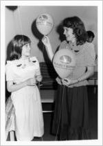 Eastern employee with girl at children's art dedication during an Eastern Air Lines promotional trip to Walt Disney World, 1983-05-11