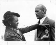 Eastern Air Lines employee placing button on lifelike mannequin of Gerald Ford at the Atlanta Airport, 1974-02-01