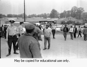 Police and protesters during the Atlanta sanitation workers strike, April 13, 1970. Here they are seen outside the Potter & Rayfield, Inc. facility, 1570 Northside Drive, Atlanta, Georgia.