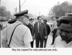 Police and protesters during the Atlanta sanitation workers strike, April 13, 1970. Here they are seen on Northside Drive, speaking with a man in a suit.