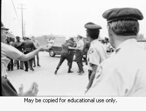 Atlanta city police at Yancey Brothers Company, struggling with a protester, during the Atlanta sanitation workers strike, April 13, 1970.