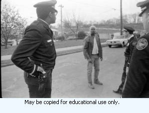 AFSCME Local 1644-led sanitation strike, Atlanta, Georgia, March 1970. These photographs are taken outside the City of Atlanta Construction Department office and warehouse (110-111 Hill Street). Protestors are apparently attempting to block strikebreakers from crossing the picket-line and entering the office area. The photograph series is labeled "Garbage Strike."
