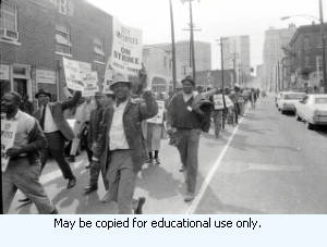 Sanitation workers strike supporters marching in downtown Atlanta, Georgia, March 31, 1970. Photograph is part of a series labeled "Strike."