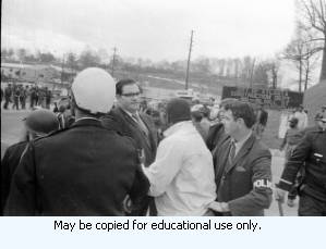 AFSCME Local 1644-led sanitation strike, Atlanta, Georgia, March 1970. These photographs are taken outside the City of Atlanta Construction Department office and warehouse (110-111 Hill Street). Protestors are apparently attempting to block strikebreakers from crossing the picket-line and entering the office area. The photograph series is labeled "Garbage Strike."