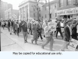 Sanitation workers strike supporters marching on Auburn Avenue, in downtown Atlanta, Georgia, March 31, 1970. Photograph is part of a series labeled "Strike."