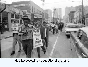 Sanitation workers strike supporters marching on Auburn Avenue, in downtown Atlanta, Georgia, March 31, 1970. Photograph is part of a series labeled "Strike."