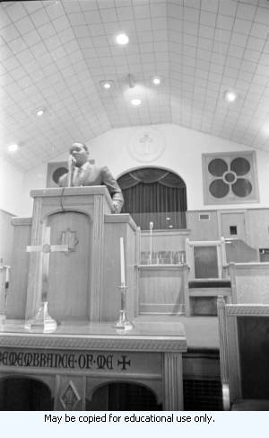 African-American man in suite speaking from a church pulpit, Atlanta, Georgia, March 1970.