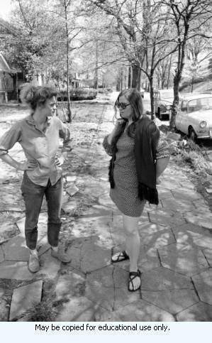 Two women standing on tree-lined street, Atlanta, Georgia, April 4, 1970.