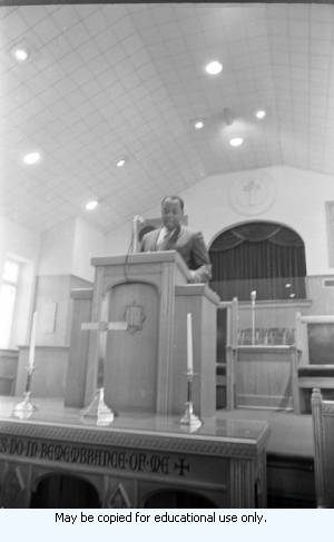 African-American man in suite speaking from a church pulpit, Atlanta, Georgia, March 1970.