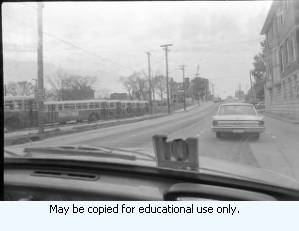 Distant view of demolition of building in downtown Atlanta, Georgia, March 1970. Photo taken from inside of automobile.