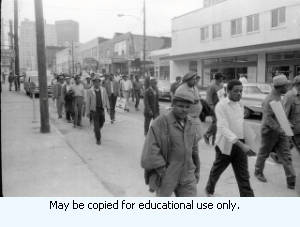 Sanitation workers strike supporters marching on Auburn Avenue, in downtown Atlanta, Georgia, March 31, 1970. Photograph is part of a series labeled "Strike."
