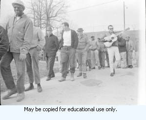 AFSCME Local 1644-led sanitation strike, Atlanta, Georgia, March 1970. These photographs are taken outside the City of Atlanta Construction Department office and warehouse (110-111 Hill Street). Protestors are apparently attempting to block strikebreakers from crossing the picket-line and entering the office area. The photograph series is labeled "Garbage Strike."