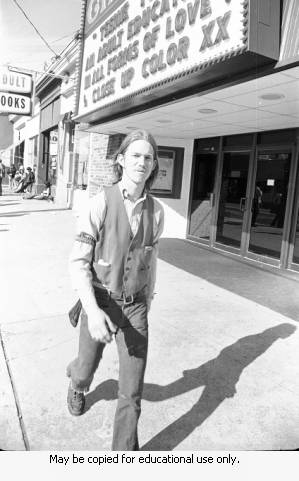 Man walking on sidewalk, April 10, 1970.