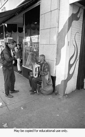 Musician on Street sidewalk, April 3, 1970.