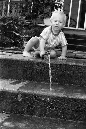 Family photos: Tom and Stephanie Coffin's child with a garden hose, Atlanta, Georgia, June 1, 1974.