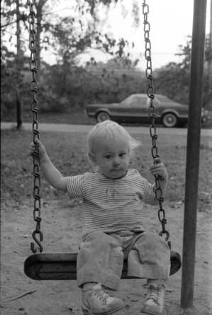 Family photos: Tom and Stephanie Coffin's child outdoors on a swing, Atlanta, Georgia, September 1, 1974.