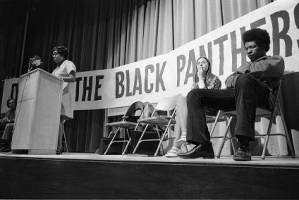 Michael Cetewayo Tabor waiting to speak at a Black Panther Party meeting, 1970