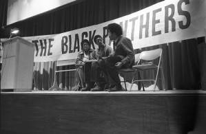 Michael Cetewayo Tabor waiting to speak at a Black Panther Party meeting, 1970