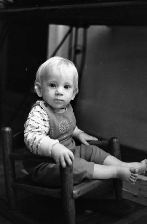 Zachary Coffin sitting in a small rocking chair, 1969