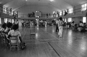 African American community gathered together inside a gymnasium, 1969