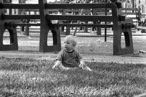Zachary Coffin sitting on grass, 1969