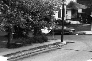 Ice-cream man riding his cart through a neighborhood, 1969