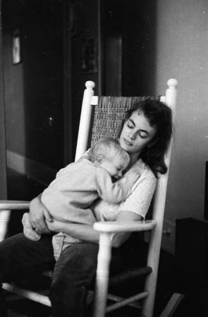 Stephanie Coffin holding her son Zachary in a rocking chair, 1969