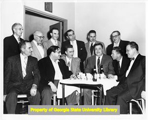 Union members sitting and standing around a table