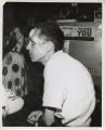 Ed King, with a bandaged face, sitting with coffee