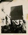 Protester with sign, "Help up Communist Youth"