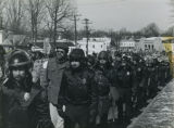 Police line the side of a protest march
