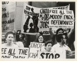 Protesters with signs, "Free all the Moody Park defendants. Moody Park Barrio Defense Coalition"