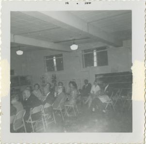 Group seated in folding chairs