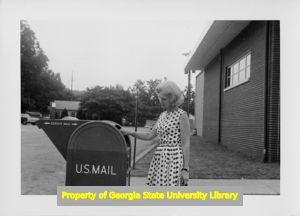 Woman depositing mail in Cartersville, Georgia.