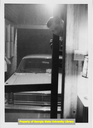 E-Z Mills employee peeking through a garage door.