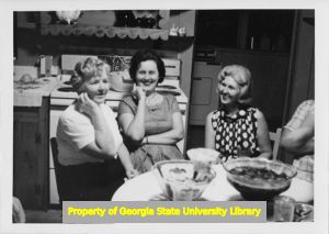 Three women sit around a kitchen table in Cartersville, Georgia.