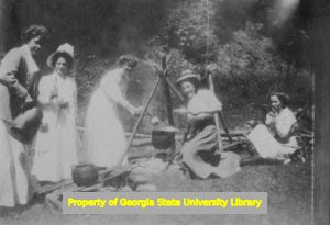 Women cooking around a fire, C. J. French collection