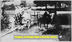 Group in cart next to horse drawn carriage, C. J. French collection