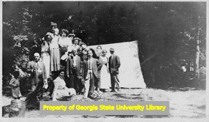 Campers posing in front of tent, C. J. French collection