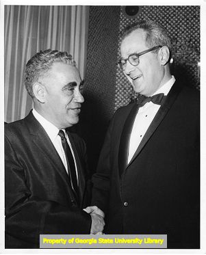 United Furniture Workers President Morris Pizer shaking hands.