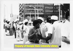 SEIU member leafletting a parade in support of the United Furniture Workers labor dispute with Office Equipment Distributors, Atlanta, Georgia, June 1982.