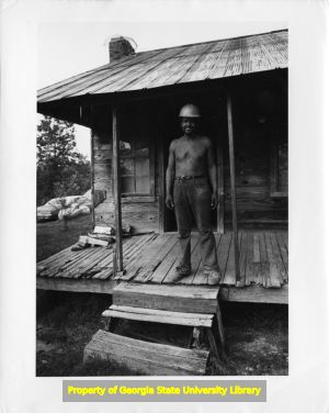 Woodcutter outside cabin