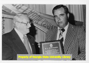 George Caudelle presents an award to E. L. Abercrombie, Atlanta, Georgia, November 1975.
