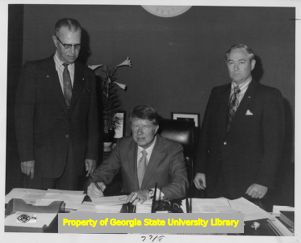 Governor Jimmy Carter signing a document, circa 1972.