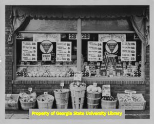 Exterior and window display at a Pender Grocery, 1933.