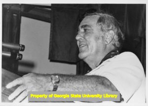 Herb Green speaking at podium, circa 1976.