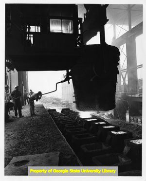 Atlantic Steel Company employee pouring heated steel into ingots, Atlanta, Georgia, late 1960s.
