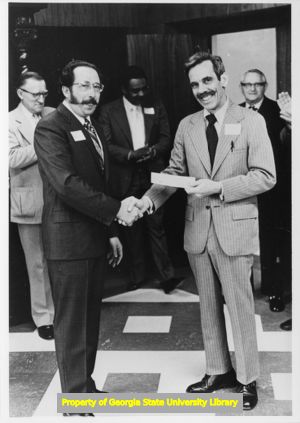 William R. Pullen receiving check for the establishment of the Southern Labor Archives from James Sala, Atlanta, Georgia, circa 1969.